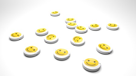 Happy drugs, tablets that cure sadness and bad mood - white round pills with a small yellow smiley emoticon symbolize a drug that does not exist but everybody wants: happy pills without side effects.の写真素材