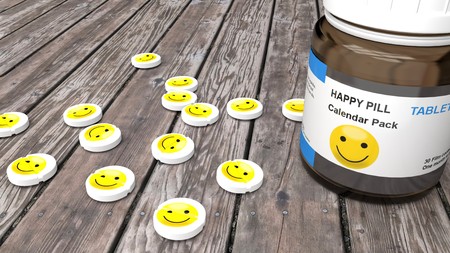 Happy pills, sad mood treatment monthly pack - round, white pills with a grinning, happy, yellow...