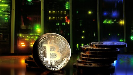 Dark server room with colorful lights and a bunch of golden bitcoins, close up, 3d illustrationの写真素材