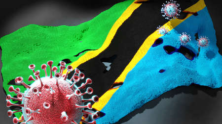 virus attacking a national flag of Tanzania United Republic of as a symbol of a fight and struggle with the virus pandemic in this country, 3d illustrationの写真素材