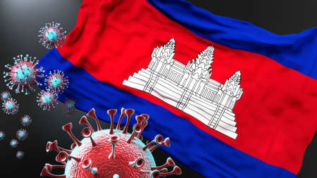 Cambodia and the covid pandemic - corona virus attacking national flag of Cambodia to symbolize the fight, struggle and the virus presence in this country, 3d illustrationの写真素材