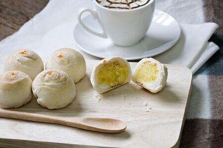 Dessert Chinese pastry or mooncake on wooden with coffeeの写真素材