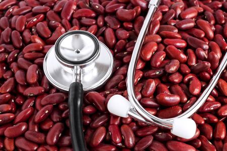 A pile of many red beans with stethoscope is a medical instrument isolated on white background. Concept food for healthy.の写真素材