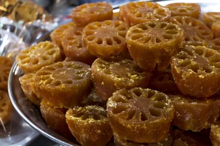 Bael fruit or Aegle marmelos preserved by sweet syrup on container for sale at the asian market or street food.の写真素材