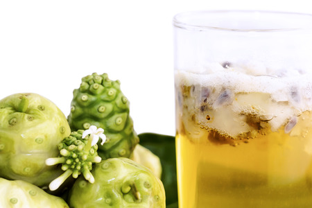 Noni fruit juice or Morinda Citrifolia and noni slice for health on the white table isolated on gray background with copy space for text. (with clipping path)の写真素材