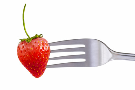 Strawberry on fork isolated on white background which fresh juicy ripe red for dessert and food concept.の写真素材