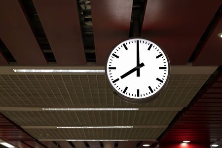 Public clock in railway station at the hanging with roof of subway central station. It is clock for watch time waiting train.の写真素材