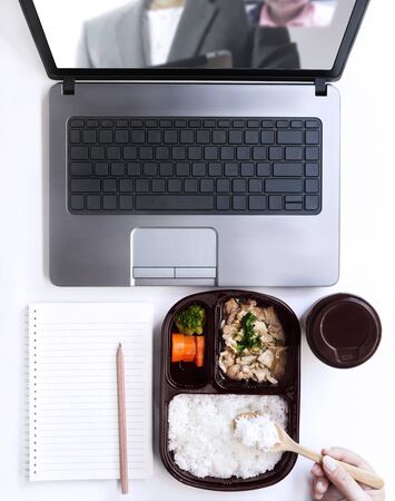 Woman working from home on laptop and making online order food form restaurant which have delivery service ready meal. Female stay at home self-quarantine for protective during coronavirus outbreak.の写真素材