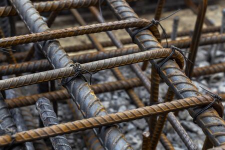 Rebar tie wire work at construction site. Steel bars reinforcing for reinforced concrete and building structures.の写真素材
