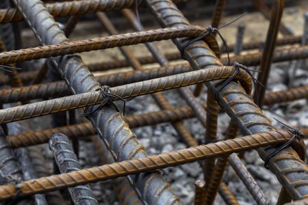 Rebar tie wire work at construction site. Steel bars reinforcing for reinforced concrete and building structures.の素材 [FY310150532443]