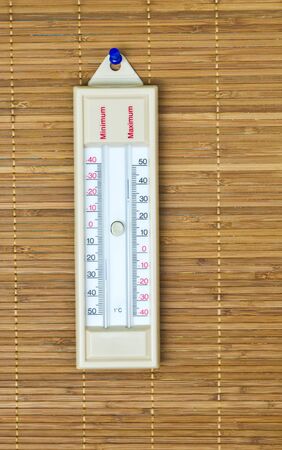 Thermometer hanging on the walls of bamboo.