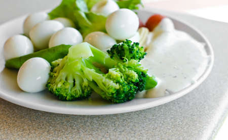 Quail eggs, vegetables and salad dressing  are healthy food 
