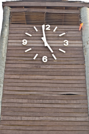 White clock on old wooden wall 