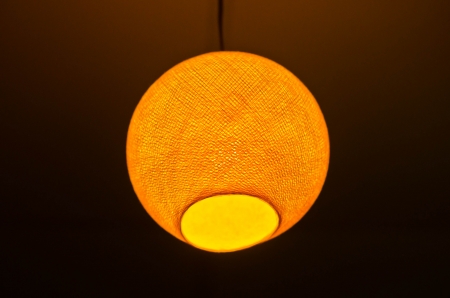 Yellow light hanging on the ceiling の写真素材