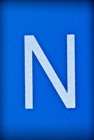 Letter N of the alphabet on blue background 