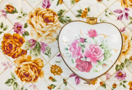 Heart shaped gift box on fabric patterns background の写真素材