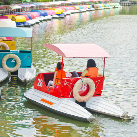 Young couple enjoying a trip in a boat in the lake の写真素材