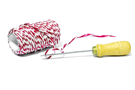 Tool with red and white thread for drill and bind the paper on a white background