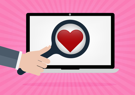 Human hand hold a magnifying for find love and heart icon on laptop monitor on pink rays in background. Concept for online internet dating.のイラスト素材
