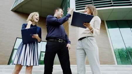 happy boss gives high five to his assistant