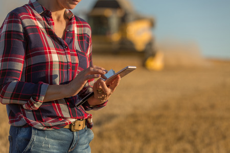 female farmer and combine harvesterの写真素材