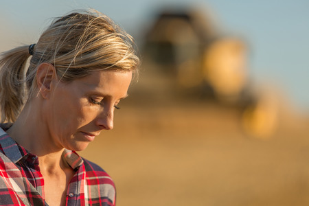 female farmer and combine harvesterの写真素材