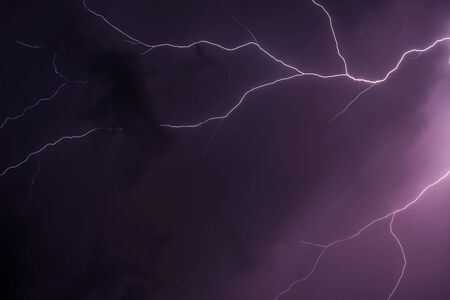 Beautiful dark storm sky, Lightning strike on the dark cloudy skyの写真素材