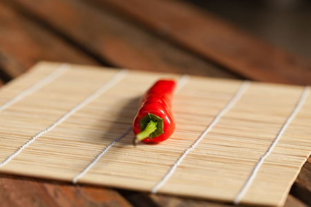 Red Chile on bamboo matの写真素材