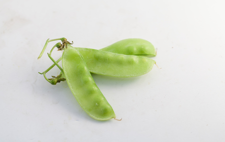 Fresh green peas islated on a white backgroundの写真素材