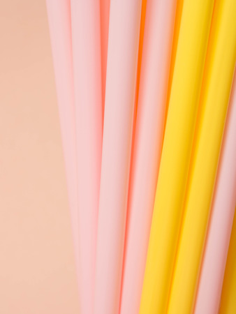straws pink and yellow backgroundの写真素材