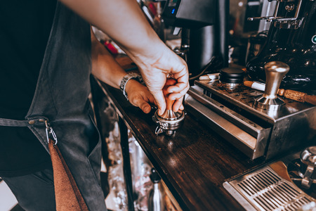 Barista making fresh coffee with machine in coffee shop or cafe.の写真素材