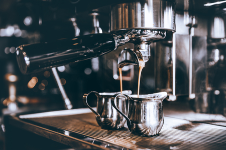 Professional Barista making fresh Espresso coffee with machine in coffee shop or cafe.の写真素材
