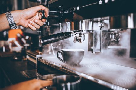 Barista making fresh coffee with machine in coffee shop or cafe.の写真素材