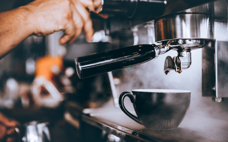 Professional Barista making fresh Espresso coffee with machine in coffee shop or cafe.の写真素材