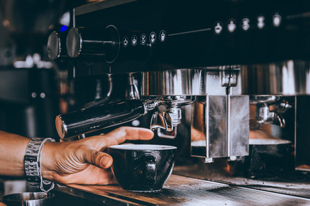 Professional Barista making fresh Espresso coffee with machine in coffee shop or cafe.の写真素材