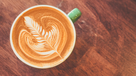 coffee latte art on wood table flat lay , relax time, cafe barista art top view.の写真素材