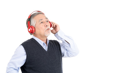 happy asian senior old man listening to music with headphones and copy space for your promotional or text isolated on white background,People lifestyle concept.の写真素材