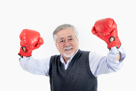 healthy fighter elderly man or business old man sport boxing red gloves copy space for your advertisement or promotional text on white background.の写真素材