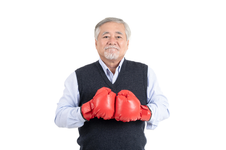 healthy fighter elderly man or business old man sport boxing red gloves copy space for your advertisement or promotional text on white background.の写真素材