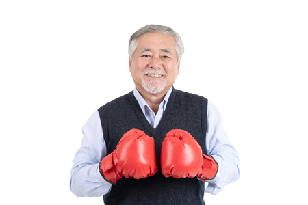 healthy fighter elderly man or business old man boxing red gloves copy space for your advertisement or promotional text on white background.の写真素材