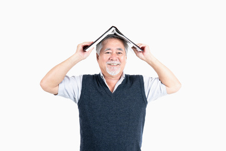 Senior male look at camera hold book with copy space for your promotional or text isolated on white background, People lifestyle concept.の写真素材