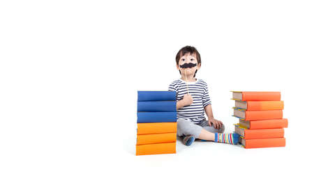 little boy wearing glasses with books on white background, education concept.の写真素材