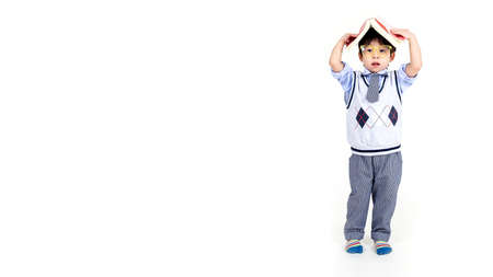 little boy wearing glasses with books on white background, education concept.の写真素材