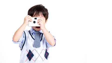 little boy play with phone on white background.の写真素材