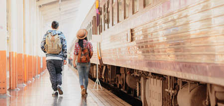asian woman and man traveler backpack enjoying travel holiday backpack adventure by train.