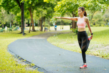 asian young woman stretching exercises in park, Sports healthy lifestyle concepts.