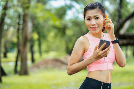 asian young woman stretching exercises in park, Sports healthy lifestyle concepts.の写真素材