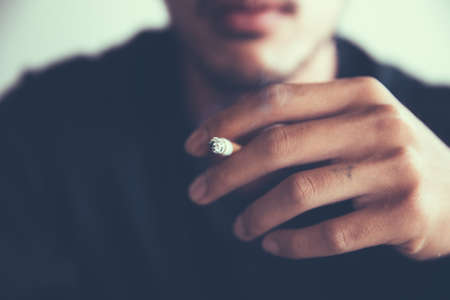 close up hands man smoking.の写真素材