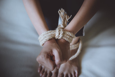 criminal tying hands with handcuffs.の写真素材