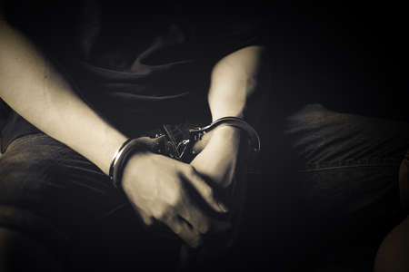 criminal tying hands with handcuffs.